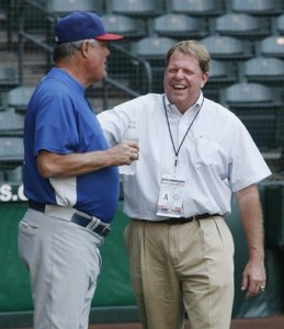 The Chicago Cubs General Manager Hendry laughs with manager Piniella during the team's workout at Chase Field in Phoenix